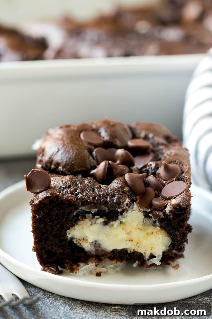 A perfectly portioned slice of earthquake cake on a white plate, highlighting its rich layers and gooey center.