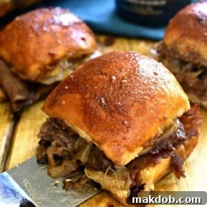 An image of three Guinness beef sliders on a board.