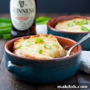 A warm, inviting bowl of Guinness soup, topped generously with melted cheese, promising a rich and satisfying Irish-inspired experience.