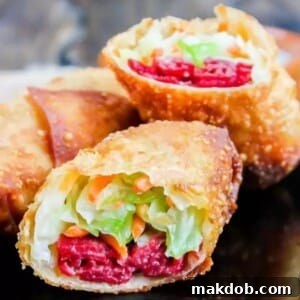 A picture of an Irish egg roll cut in half showing corned beef and cabbage.
