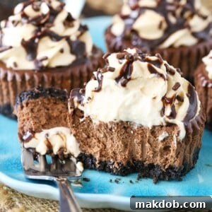 An image of a mini Baileys chocolate cheesecake cut in half with a fork.