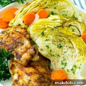 A serving of perfectly braised cabbage, tender and flavorful, accompanied by roasted carrots and onions, ready to be enjoyed as a comforting side dish.