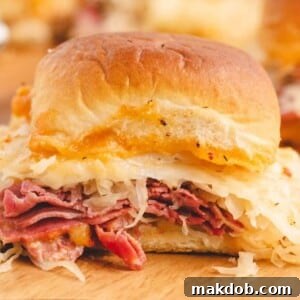 A tempting image of a baked Reuben slider sandwich, golden brown and filled with delicious ingredients, perfect for a casual meal or appetizer.