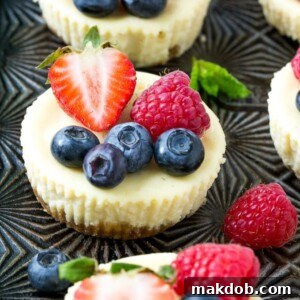 This recipe for Greek yogurt cheesecakes is mini cheesecakes that have been lightened up with Greek yogurt and topped with fresh berries. A quick and easy sweet treat! #CloverGreekYogurt ad