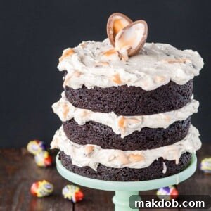 An image of a chocolate Cadbury Creme Egg Cake on a cake stand.