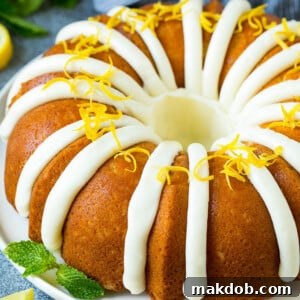 A lemon bundt cake topped with cream cheese frosting and lemon zest.