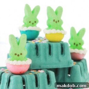 Green Peeps jello shots elegantly arranged in egg cups, a festive and fun adult treat.