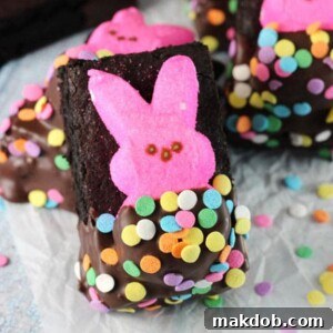 An image of delicious brownies featuring pink bunny Peeps partially covered in chocolate, a perfect Easter treat.