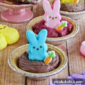 Bunny Peeps nestled in small, chocolate-filled pie crusts, creating charming s'mores pies.