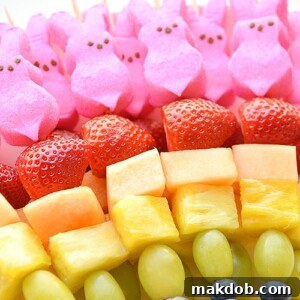 Colorful fruit skewers featuring a rainbow of fresh fruits and charming pink bunny Peeps.