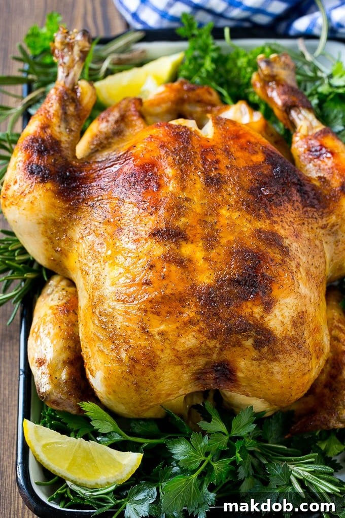 Slow Cooker Whole Chicken | Slow Cooker Rotisserie Chicken | Crock Pot Roasted Chicken | Crock Pot Whole Chicken #chicken #slowcooker #crockpot #glutenfree #dinner #dinneratthezoo Slow cooker whole chicken with broiled crispy skin, garnished with lemon and herbs, ready to be served.