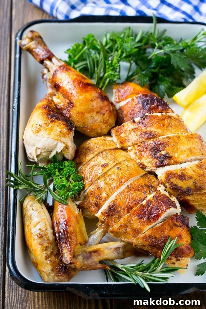 Slow Cooker Whole Chicken | Slow Cooker Rotisserie Chicken | Crock Pot Roasted Chicken | Crock Pot Whole Chicken #chicken #slowcooker #crockpot #glutenfree #dinner #dinneratthezoo A beautifully carved platter of slow cooker whole chicken with crispy skin, garnished and ready to serve.