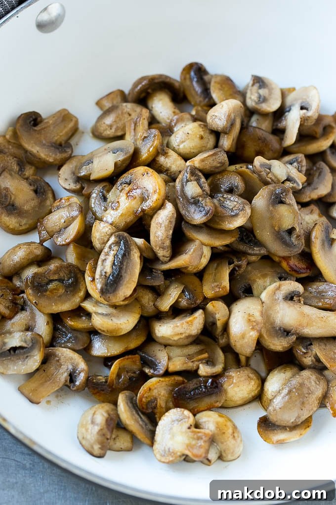 Mushroom Pork Chops Recipe | Boneless Pork Chop Recipe | Pork Chops with Mushroom Sauce #pork #porkchops #mushrooms #dinner #dinneratthezoo A pan of sauteed mushrooms form the base of mushroom sauce for pork chops.