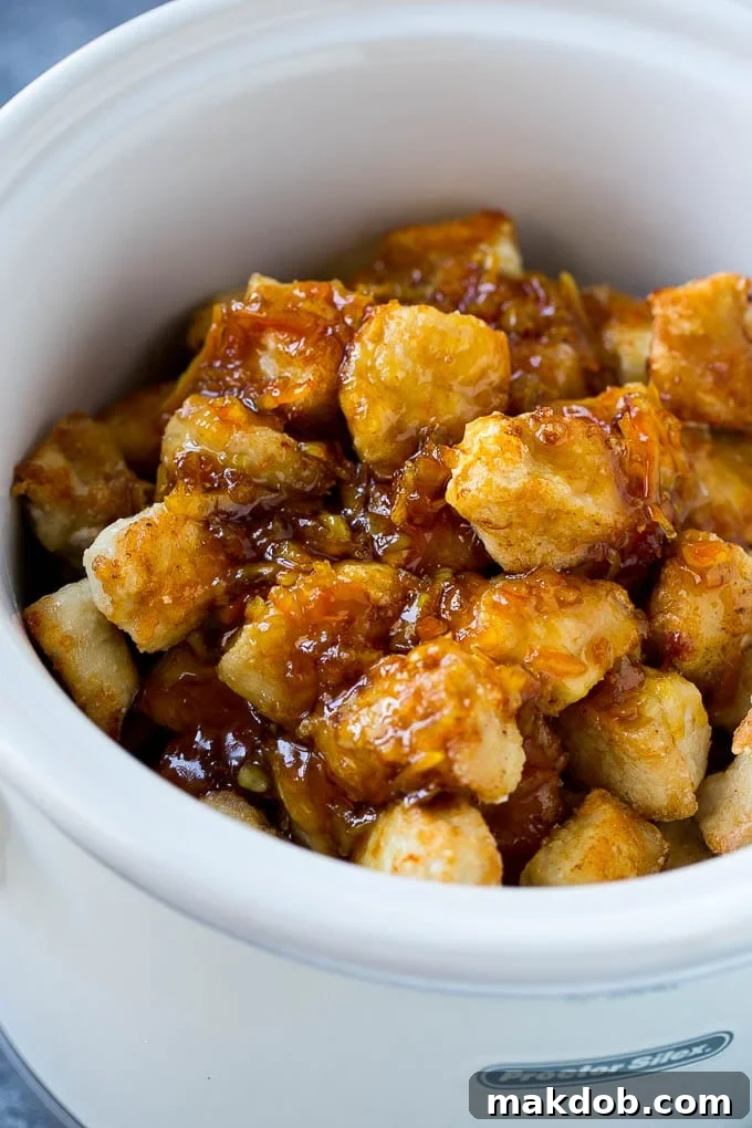Slow Cooker Orange Chicken Recipe | Copycat Orange Chicken | Crock Pot Orange Chicken | Slow Cooker Chicken Recipe #orange #chicken #orangechicken #slowcooker #crockpot #dinner #dinneratthezoo Breaded chicken in a slow cooker coated with a sweet and savory sauce.