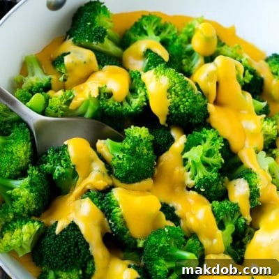 Velvet Cheese Broccoli 2 A pan of broccoli with cheese sauce that's full of steamed broccoli florets and homemade sauce.
