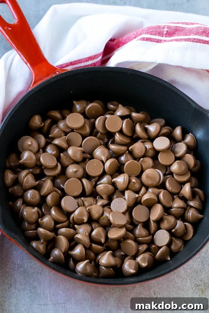 A skillet filled with a single layer of milk chocolate chips.