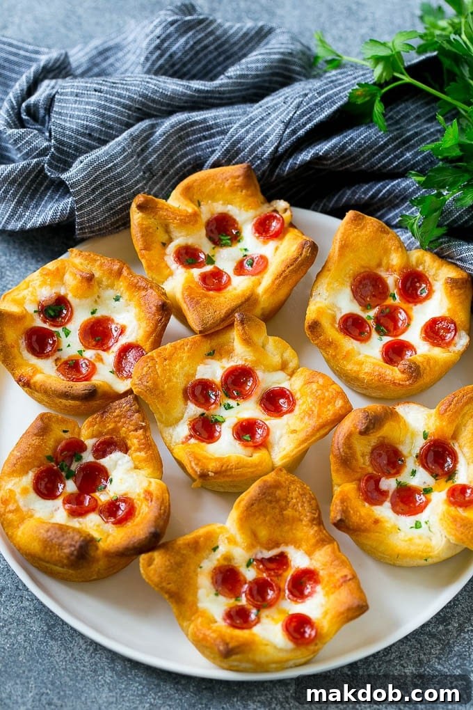 A beautiful serving plate adorned with freshly baked pizza muffins, generously garnished with vibrant fresh parsley, ready for serving.