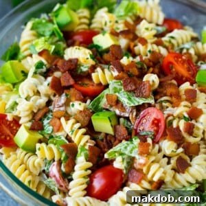 BLT pasta salad in a creamy ranch dressing, garnished with fresh parsley.