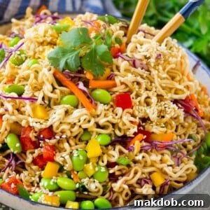 This easy Asian noodle salad recipe features ramen noodles and a vibrant array of colorful vegetables, all coated in a savory sesame hoisin dressing. It's the perfect side dish for any summer celebration or weeknight meal!