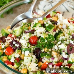A beautiful bowl of couscous salad, garnished with fresh parsley, showcasing its vibrant Mediterranean ingredients.