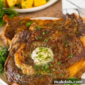 Air Fryer steak with garlic butter and herbs on top.
