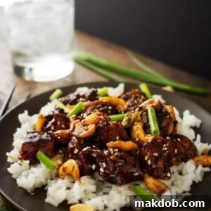 An image of spicy cashew chicken over white rice.