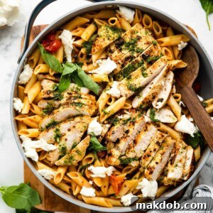 An image of tomato basil chicken pasta in a pan.