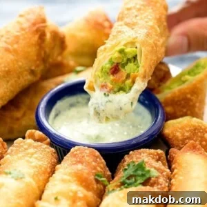 An image of an avocado egg roll dipped in sauce.