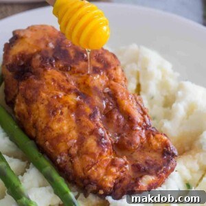 An image of truffle honey chicken on mashed potatoes.