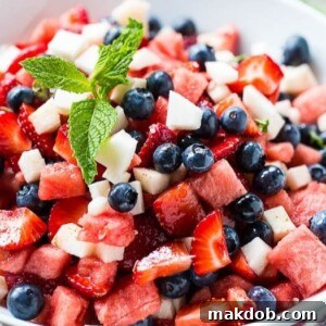A festive Red, White, and Blue Fruit Salad, beautifully composed of strawberries, blueberries, and jicama for a patriotic and refreshing treat.