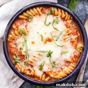 A tempting bowl of slow cooker chicken parmesan soup, showcasing its rich, comforting texture and vibrant color.