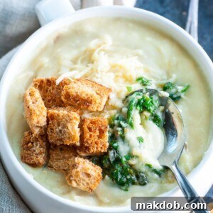 A creamy bowl of cheesy pesto potato soup, offering a comforting and flavorful twist on a classic.
