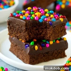 A stack of cosmic brownies on a plate with a bite taken out of one.