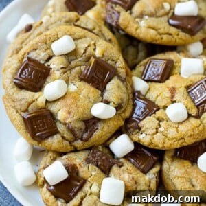 A plate of S'mores cookies topped with milk chocolate bars and marshmallows.