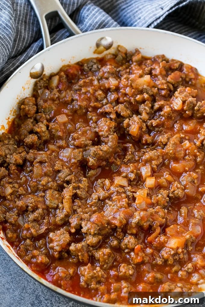 Seasoned ground beef and tomato sauce in a skillet.
