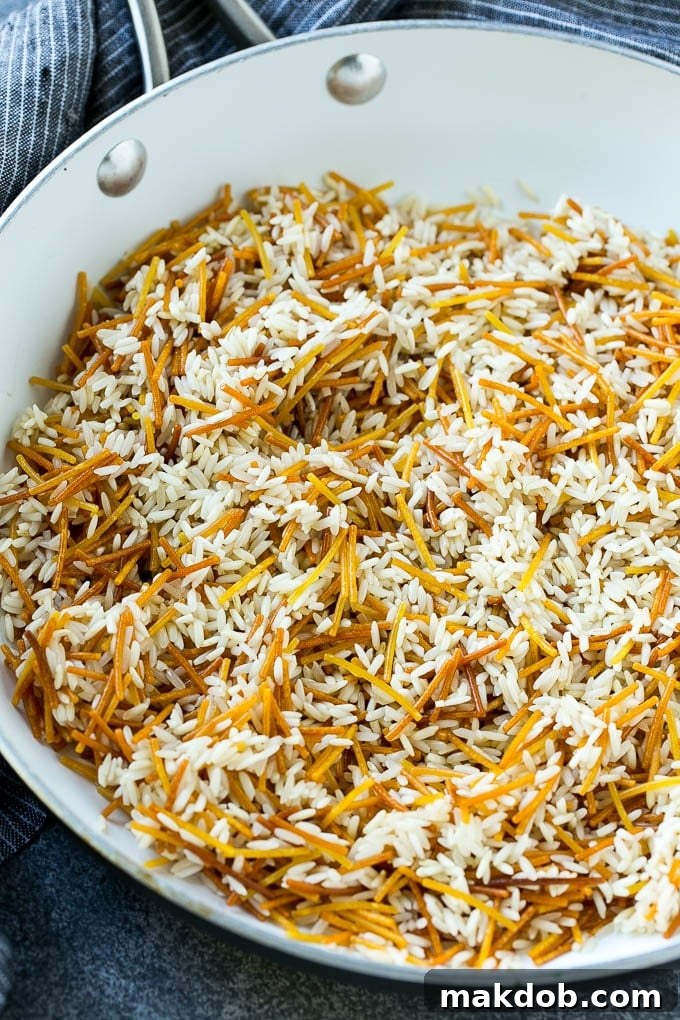 Toasted pasta and rice in a skillet.