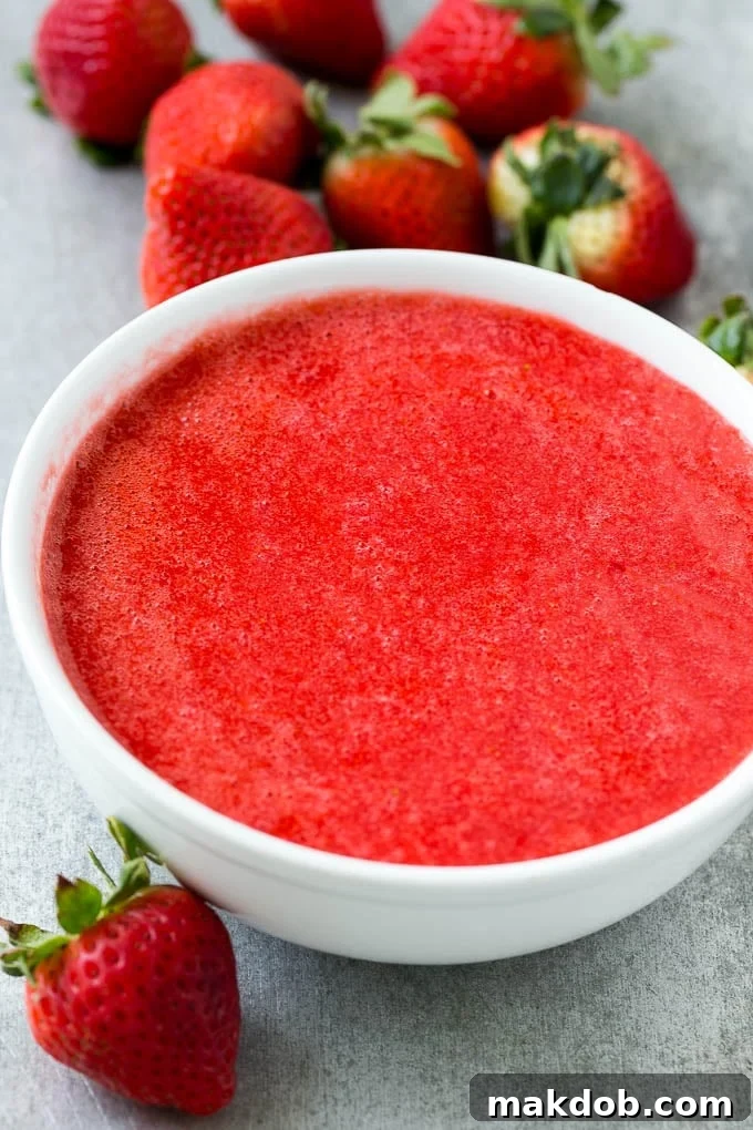 Strawberry Lemonade Recipe | Homemade Lemonade | Strawberry Drink Recipe #lemonade #strawberries #drink #dinneratthezoo A bowl filled with freshly blended strawberry puree, showcasing its smooth texture and rich, vibrant red color, ready to be incorporated into a refreshing drink.