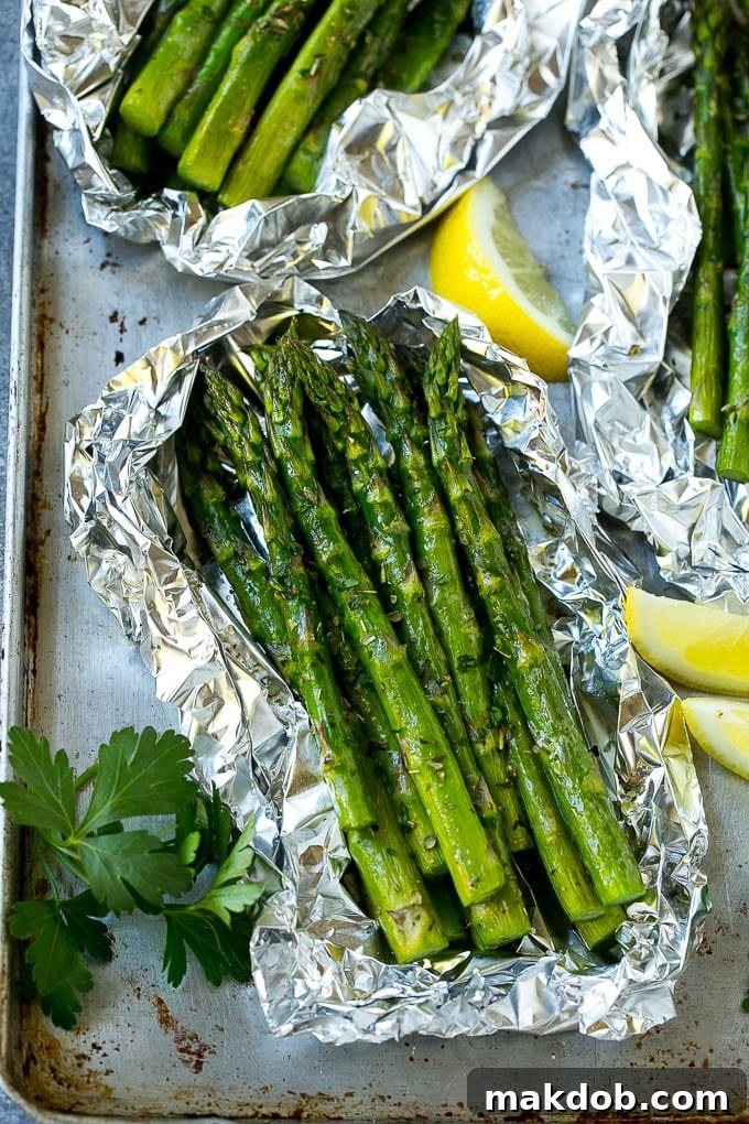 Grilled asparagus in foil topped with parsley and seasonings.