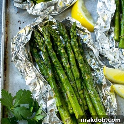 Grilled asparagus in foil topped with parsley and seasonings.