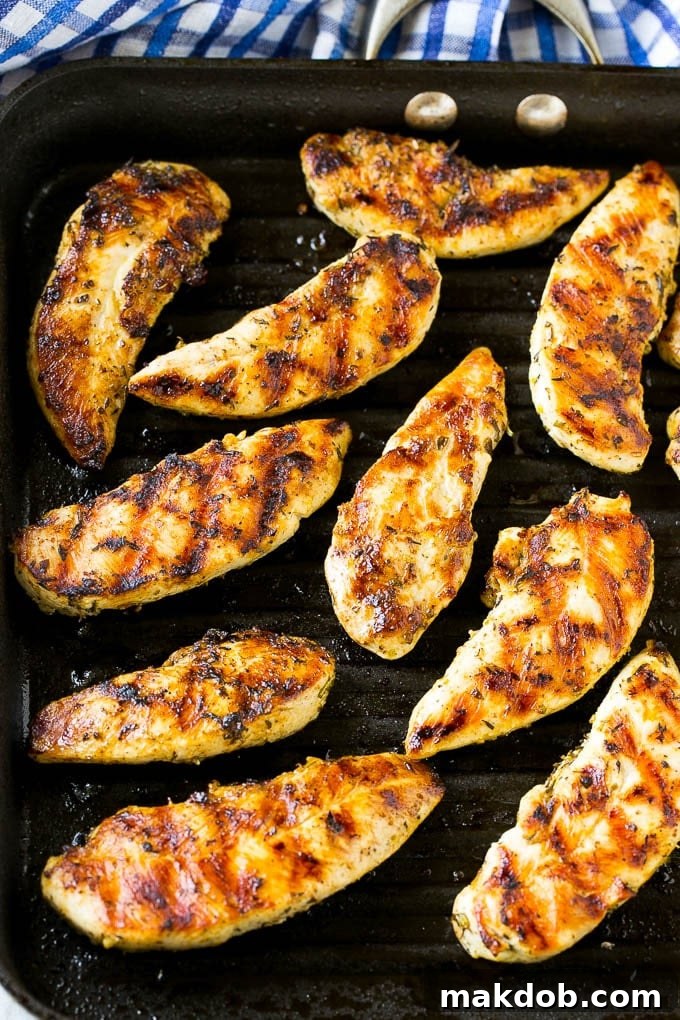 Chicken tenders cooking on a grill pan.