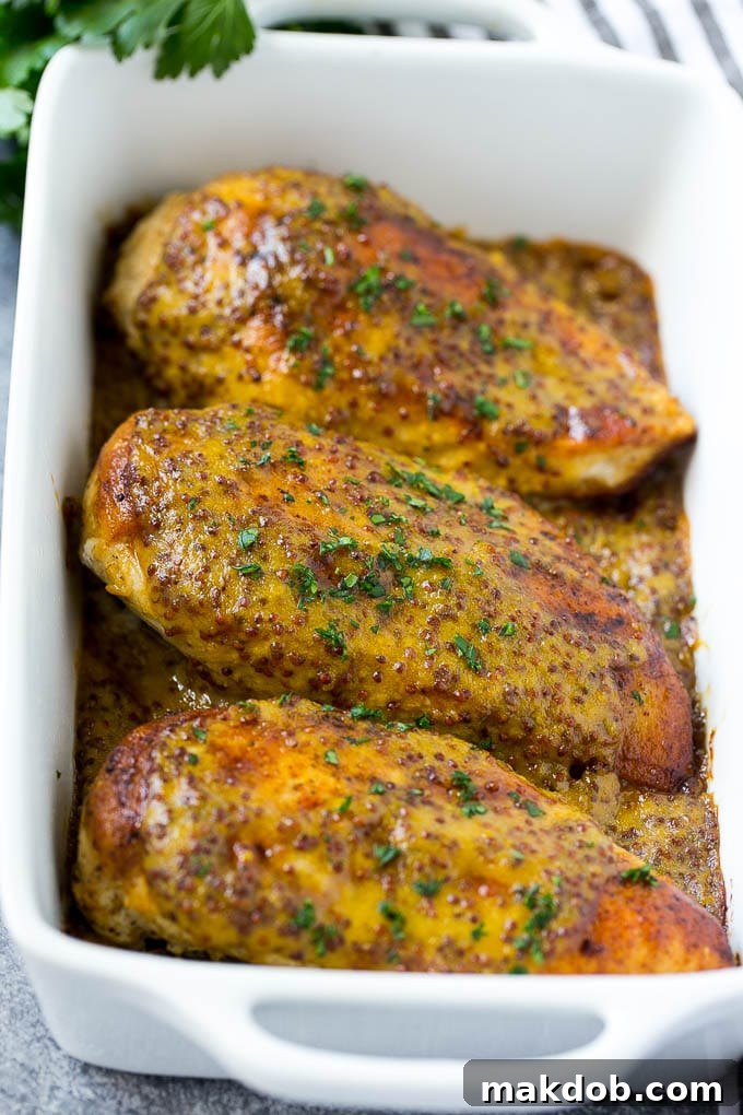 Baked honey mustard chicken garnished with chopped parsley.