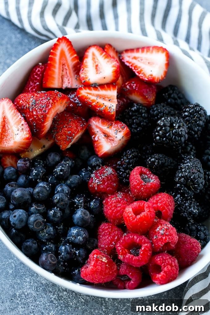 Berry Fruit Salad Recipe | Berry Salad | Summer Berry Salad | Fruit Salad Recipe #berries #fruitsalad #dinneratthezoo A bowl of blueberries, raspberries, blackberries and strawberries topped with poppy seed dressing.