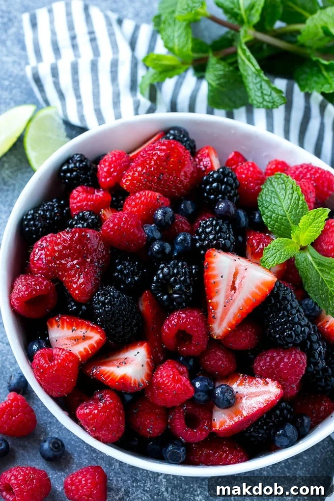 Berry Fruit Salad Recipe | Berry Salad | Summer Berry Salad | Fruit Salad Recipe #berries #fruitsalad #dinneratthezoo A bowl of berry fruit salad tossed in a honey lime dressing and garnished with fresh mint.