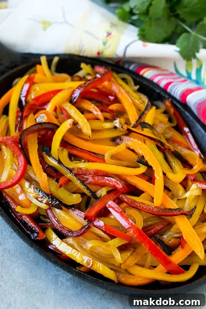 Blackened bell peppers and onions perfectly caramelized and softened in a pan, awaiting the shrimp.