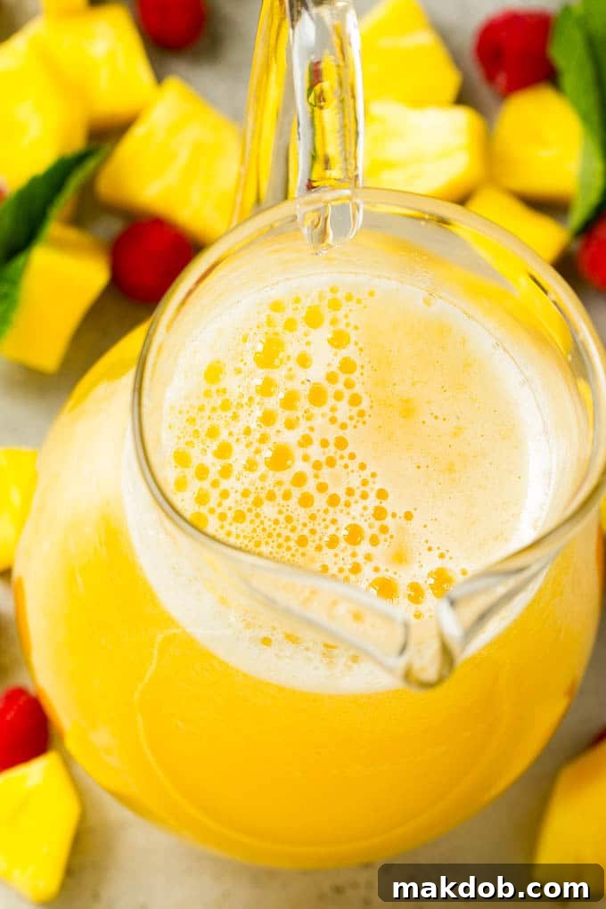 A pitcher of pineapple punch with frozen limeade, pineapple juice and lemon lime soda.