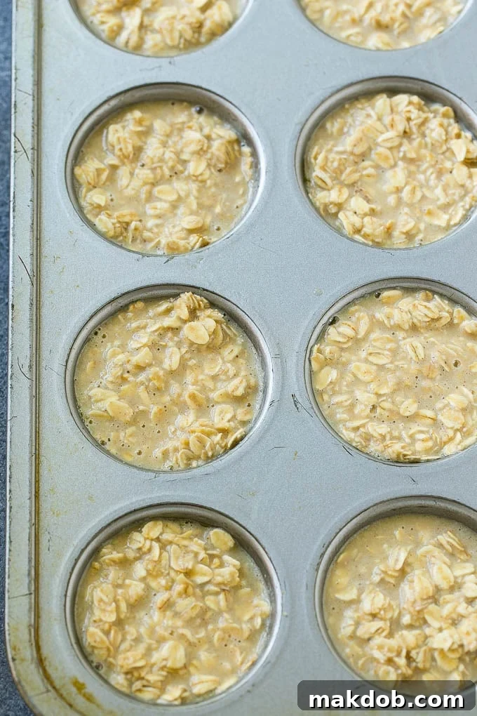 Baked oatmeal cup batter poured into muffin tins.