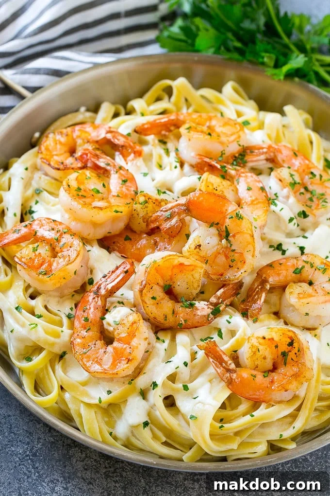 Shrimp Alfredo Recipe | Shrimp Alfredo Pasta | Shrimp Fettuccine Alfredo #shrimp #pasta #italianfood #dinneratthezoo A pan of shrimp alfredo with fettuccine, creamy parmesan sauce and garlic butter shrimp.