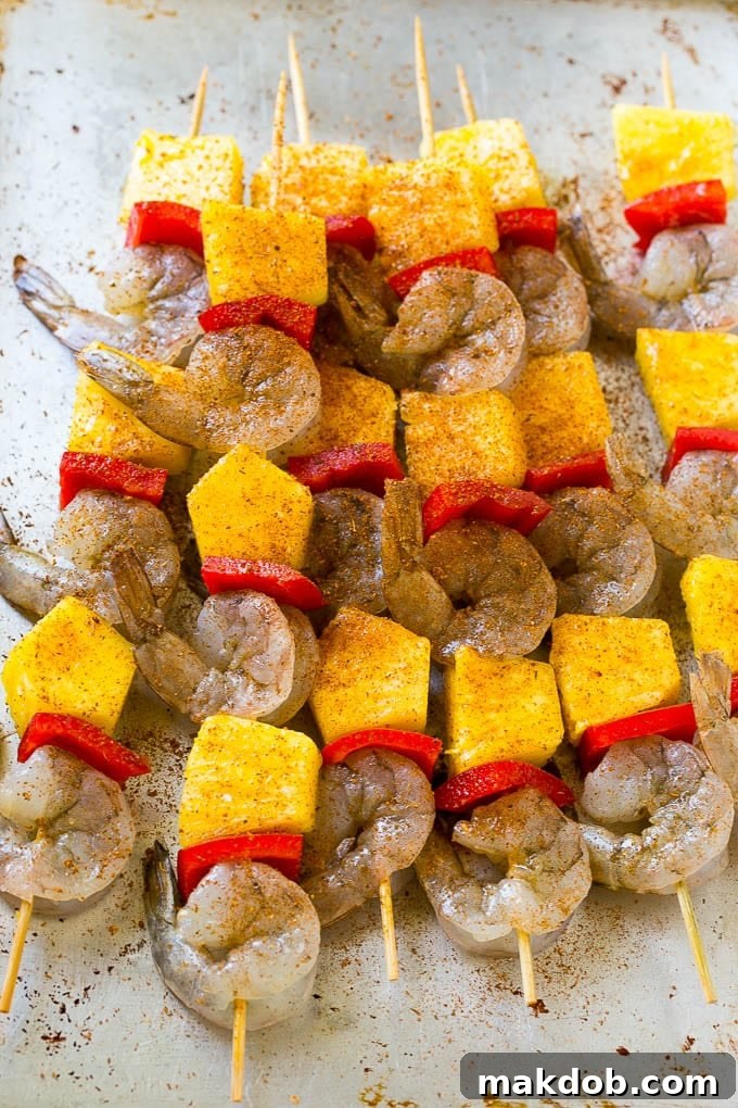 Shrimp, pineapple and peppers on wood skewers, topped with jerk seasoning.