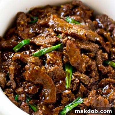 Slow cooker mongolian beef with thinly sliced flank steak cooked with soy sauce, brown sugar, garlic and ginger.
