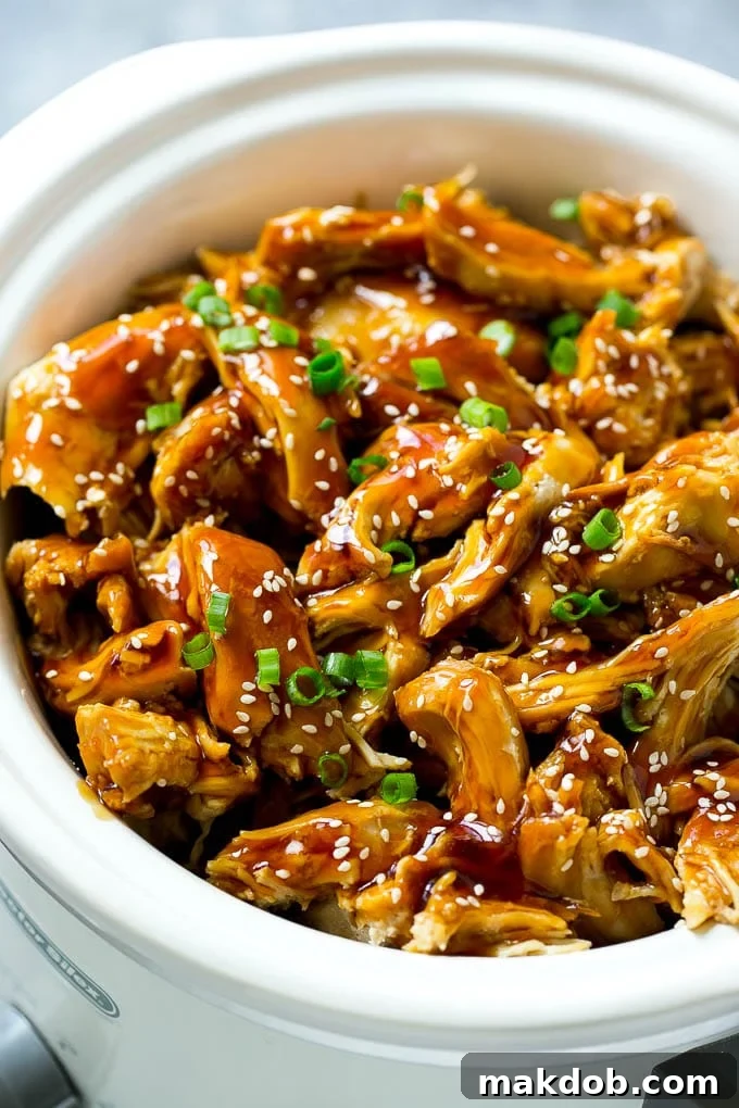 Effortless Slow Cooker Teriyaki Chicken 2 Slow cooker teriyaki chicken with shredded chicken breasts, homemade teriyaki sauce, sesame seeds and green onions.